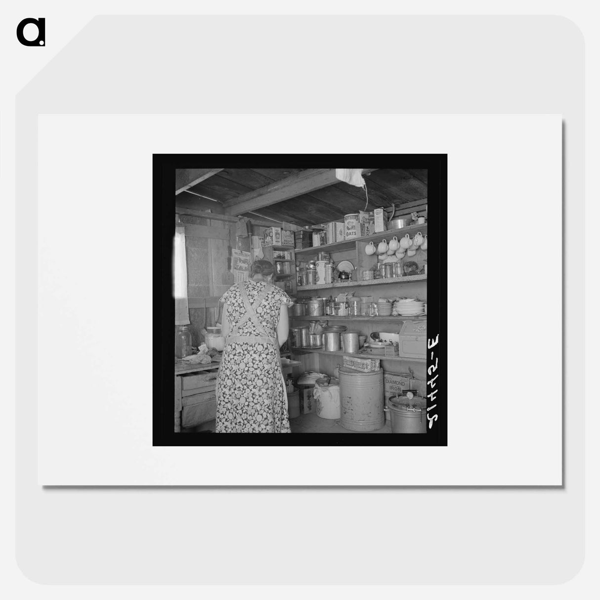 Woman getting lunch in kitchen of home - Dorothea Lange Poster.